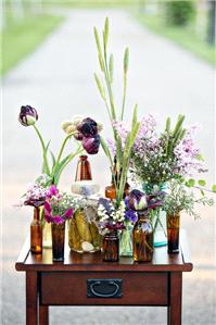 Flowers arranged in lots of different bottles