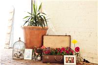 Vintage style, flowers in suitcase, photos of parents wedding day